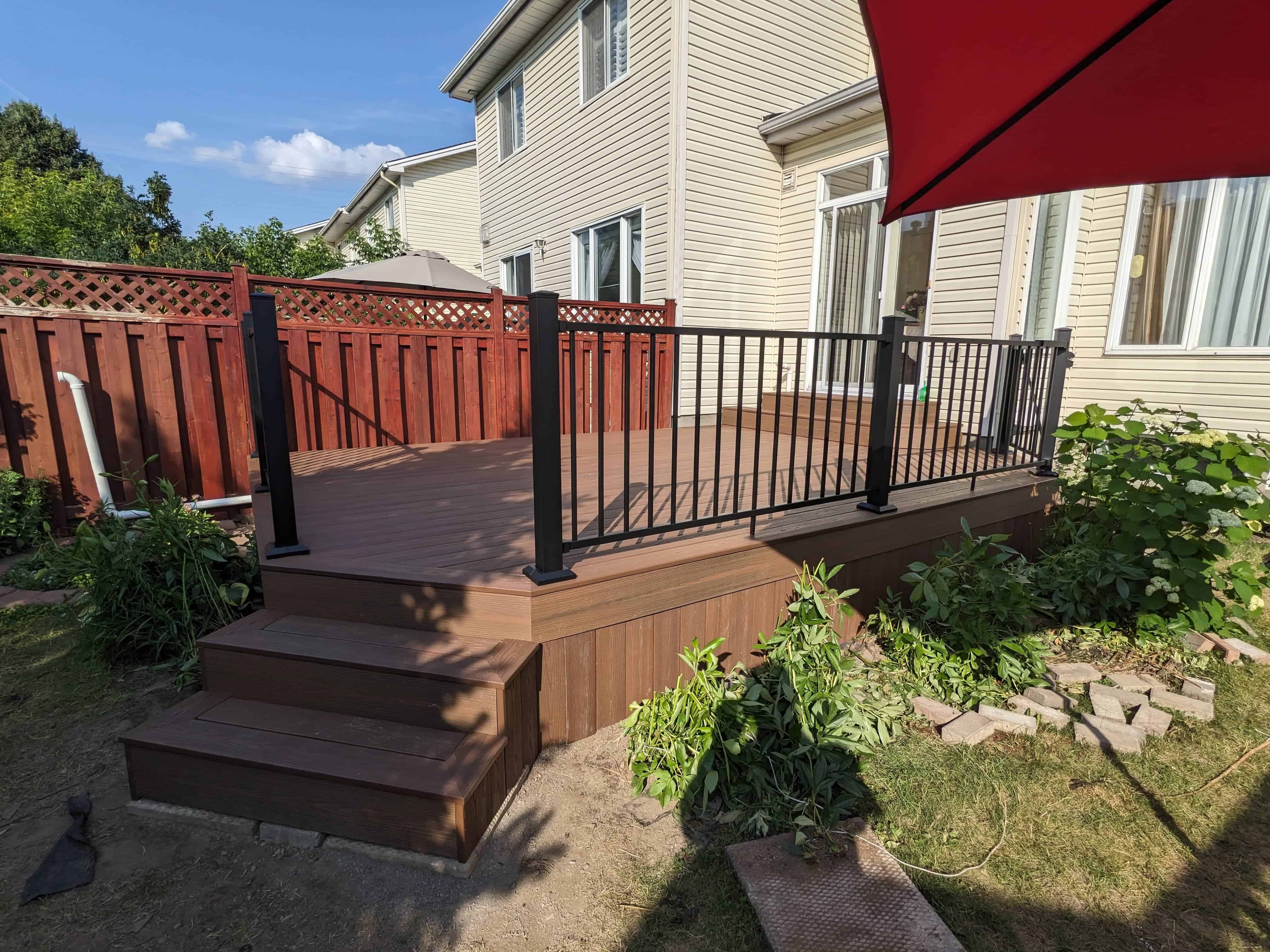 Finished wood deck with railing and privacy fence in Ottawa