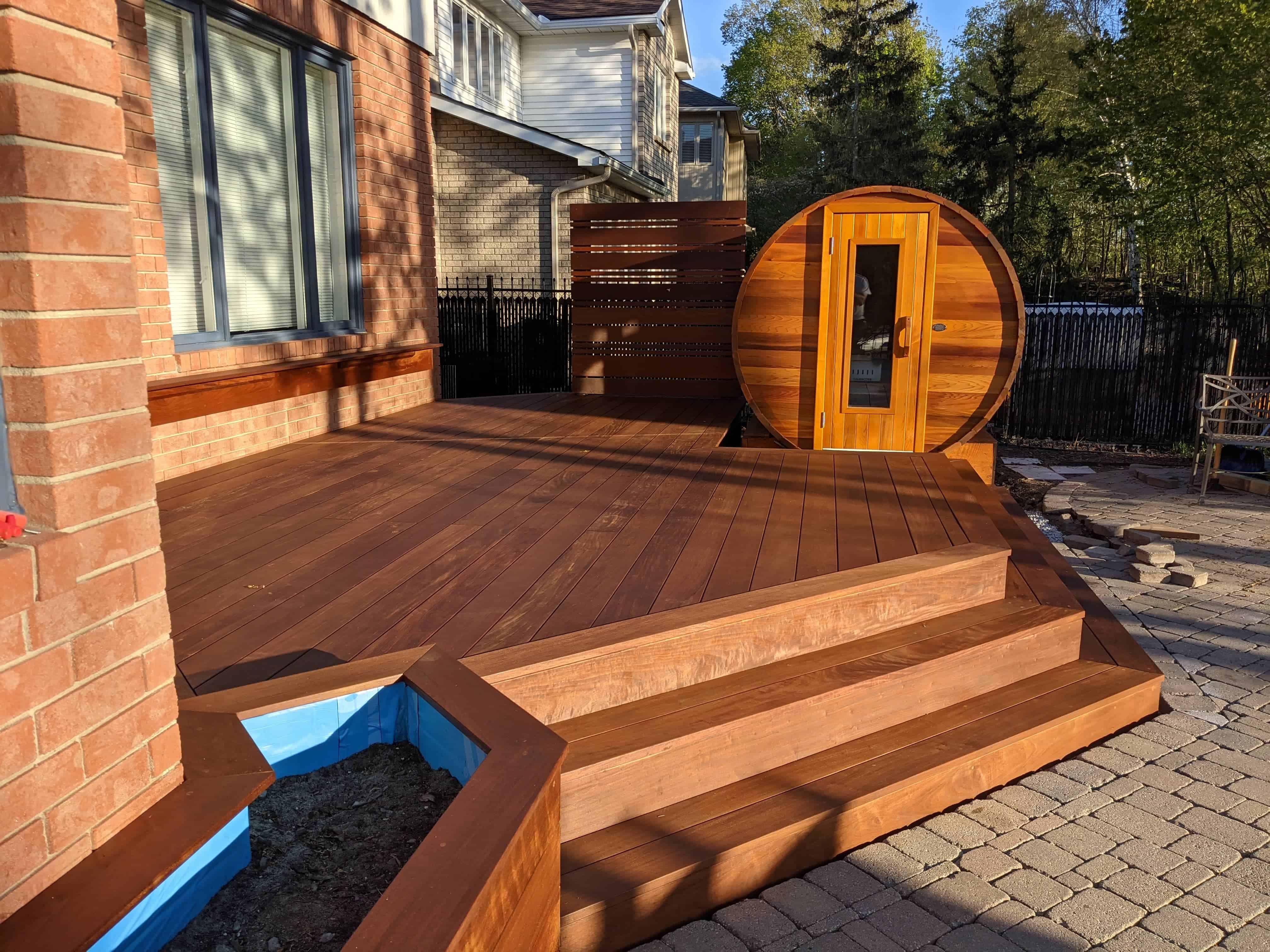 IPE deck with warm hardwood boards, stairs, and outdoor sauna in Ottawa